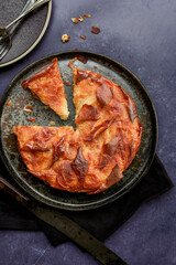 Kouign-amann pastry served on a black plate 