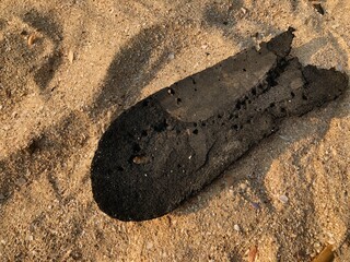 broken sandals on the beach sand