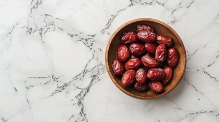 Sweet dates out of wooden bowl on marble surface
 - Powered by Adobe