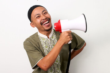 Excited Indonesian Muslim man in koko and peci shouts into a megaphone, announcing Ramadan sales...