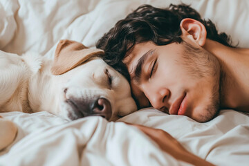 Obraz na płótnie Canvas Young man and dog sleeping together in white bed at home. Concept of animal love