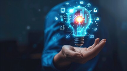 Business strategic planning ideas for investment and business growth Businessman uses his hand to support a glowing blue light bulb with futuristic graphic technology icons.
