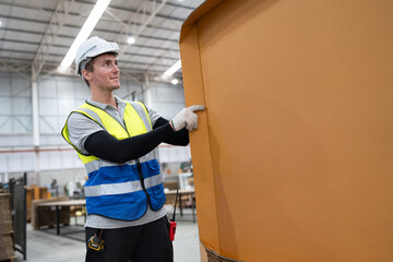 Caucasian foreman or businessman checking Kraft paper stock at warehouse	
