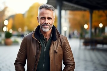 Portrait of a handsome senior man in a leather jacket outdoors.
