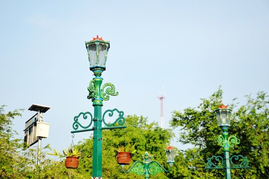 The beautiful ancient garden lamp with a classic design made of metal and painted green