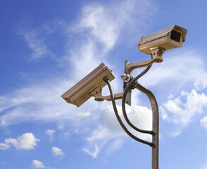 Security camera on blue sky background