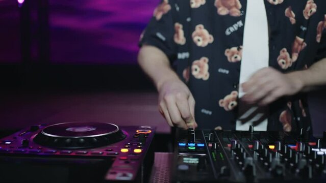 Closeup View Of DJ Hands On Mixer, Professional DJ Playing Techno Music In Rave Party
