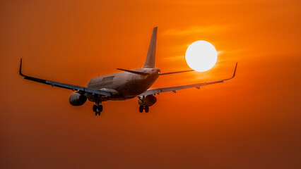 March 3, 2024: planes prepare to land at Tan Son Nhat airport, Ho Chi Minh City during sunset - obrazy, fototapety, plakaty