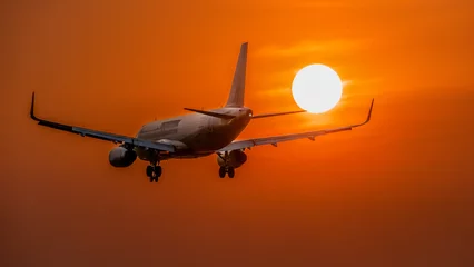 Tuinposter March 3, 2024: planes prepare to land at Tan Son Nhat airport, Ho Chi Minh City during sunset © Long