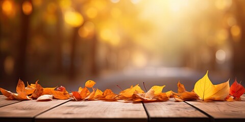 Blurred Autumn background with red-yellow leaves and wooden table. - obrazy, fototapety, plakaty