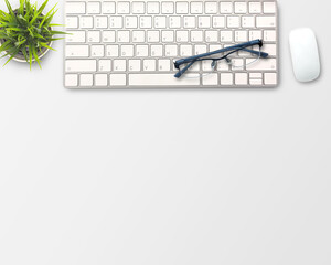 flat lay Blank notebook, computer keyboard,coffee,glasses and other office equipment on white office desk.