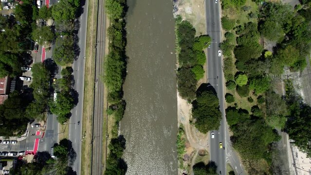 Top Down Aerial View, Street Traffic by Medellin River Colombia. Riverside Roads and Cars, High Angle Drone Shot