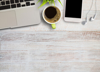 Smart phone and earphone with cup of coffee on old wooden background