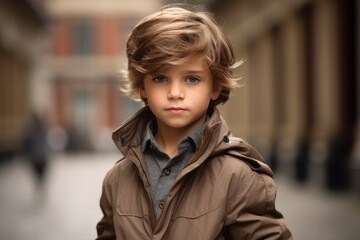 Portrait of a cute little boy with trendy hairstyle wearing a coat.