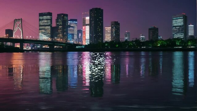 Tokyo city at night and Sumida River and silhouettes of buildings against purple sky. Seamless looping 4k video animation.