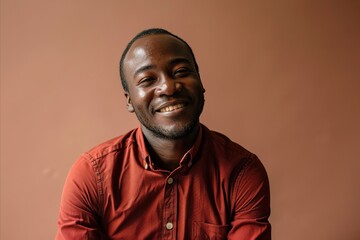 Young african american man in red shirt smiling and looking at camera