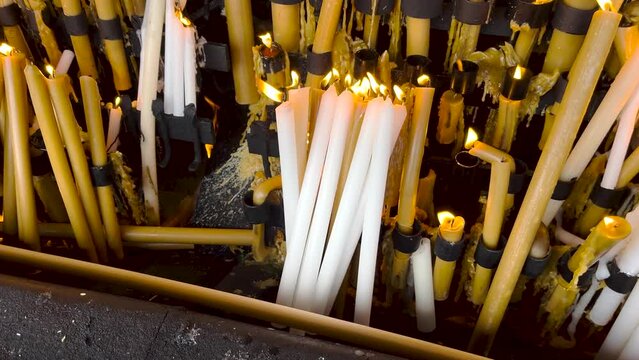 Lighting and burning candles as prayer and promise, Fatima, Portugal