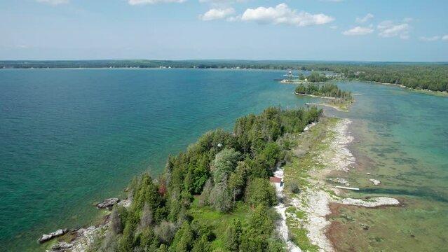 Drone aerial view of a light house on  the shores of door county and lake Michigan