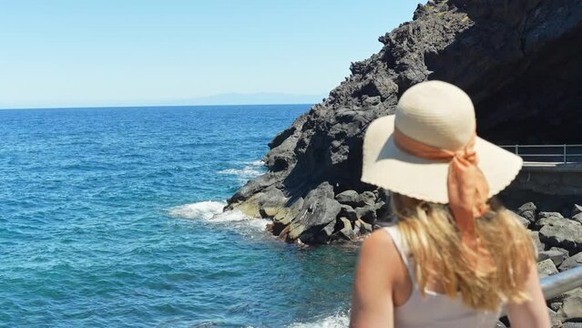 Calming sense of feminine freedom staring at shores of Candelaria Tenerife Spain