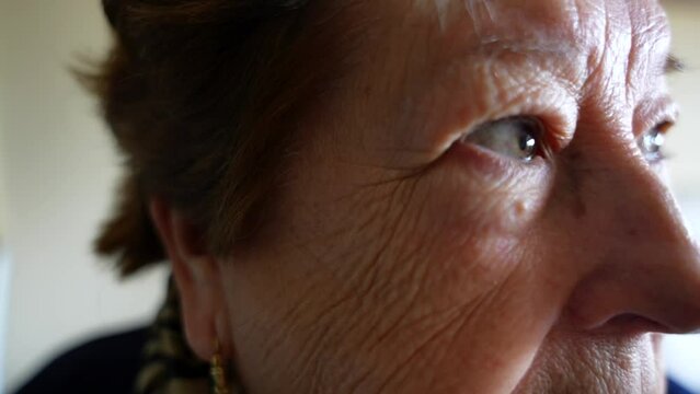 Closeup profile of old woman showing wrinkles on her face. Headshot