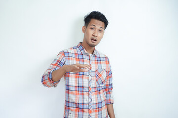 Asian man wearing flannel shirt gesturing to relax and stay calm with palms outward. calms...