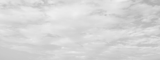 White cloud in the sky. View on a soft white fluffy cloud as background. Cloudy sky, white clouds, black background pattern. 