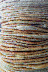 Flatbread lavash, chapati, naan, heap of tortilla on a blue background Homemade flatbread stacked.