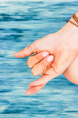 Close up mudra gesture. Woman practicing yoga on yoga mat. Wellbeing and mindfulness concept.