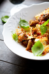 Ravioli with mushrooms and fresh basil. Dark wooden background. Close up	