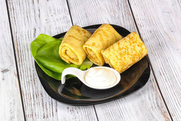 Stuffed pancakes with cream sauce