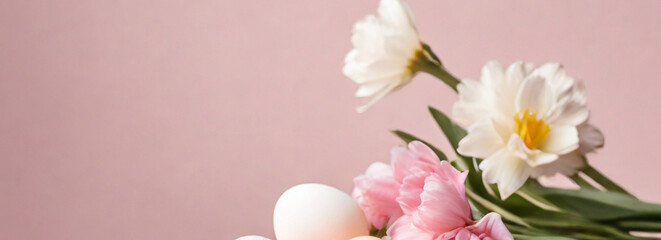 Light pink colored eggs and spring tulips flowers on pink background, beautiful Easter banner with copy space