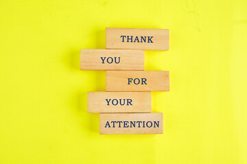 Thank you for your attention concept. Text written on wooden blocks on a lemon background. Business concept