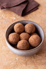 Chocolate truffle candies sprinkled with cocoa. Dessert. Vegetarian food.