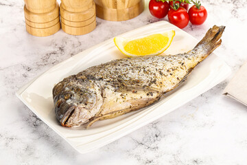 Baked Dorado fish served lemon
