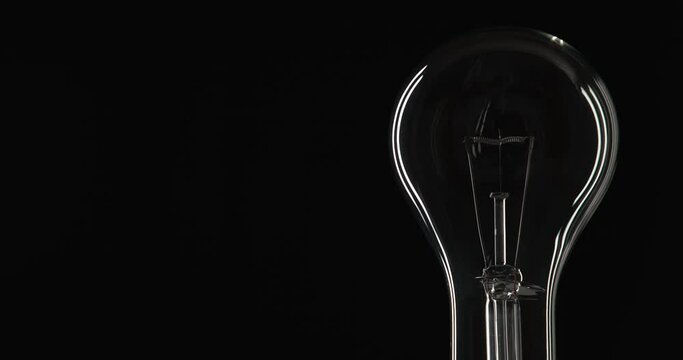 Right-Framed Shotof Clear Light Bulb Dimming To Bright Level And Going Off Again