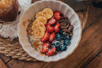 Oatmeal topped with fruit Chocolate and bee pollen