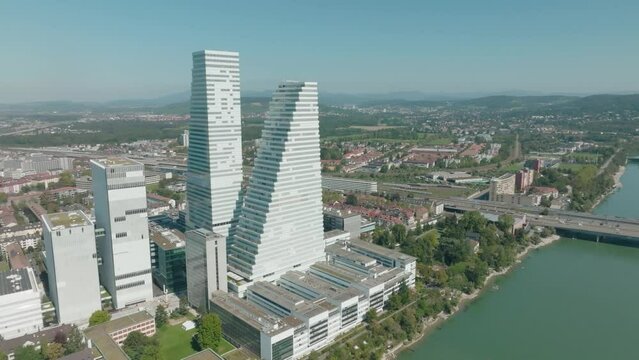 Aerial flies over Rhine river in Basel with the two Roche Towers and kleinbasel in frame