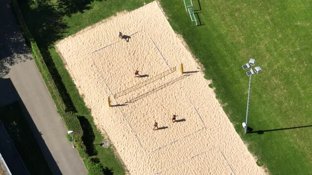 aerial bird view of people playing a match of volleyball on a sunny day in Basel