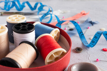Threads, buttons, zippers, centimeter and pins, sewing tools for tailoring.