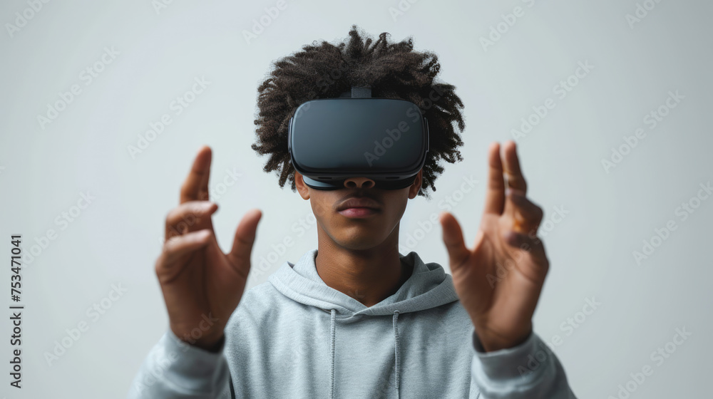 Poster a man wearing a vr headset, gesturing with his hands as if interacting with a virtual environment. a