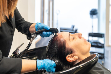 Woman washing her hair in a beauty hair salon
