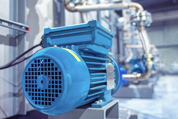 Industrial equipment. New blue electric motors with pumps on the stainless steel production line....