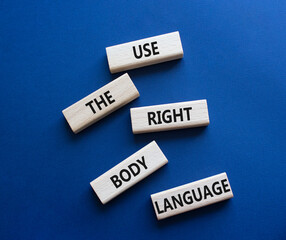 Use the right Body Language symbol. Concept words Use the right Body Language on wooden blocks. Beautiful deep blue background. Business concept. Copy space