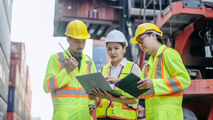 Group of professional dock worker and engineering people taking with their supervisor while record data online with digital laptop at warehouse logistic in cargo freight ship for import and export