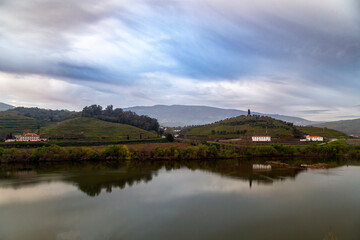 Fototapeta na wymiar View of the Douro River as it passes through the city of Peso da Regua. Vila Real, Portugal.