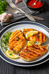 juicy grilled chicken cutlets on plate, top view