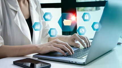 Businesswoman working on laptop with virtual screen. Online documentation database and document management system concept.