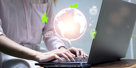 Women use a laptop to analyze ESG, environment social governance investment business concept,...