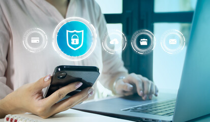 Cyber security technology, data protection concept. User using mobile phone and laptop computer with privacy security and data encryption system, secure internet access. 