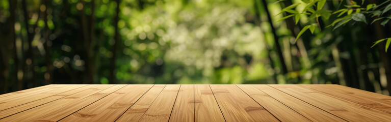 Empty wooden table over blurred bamboo background. banner, panorama, mock up for design and product...